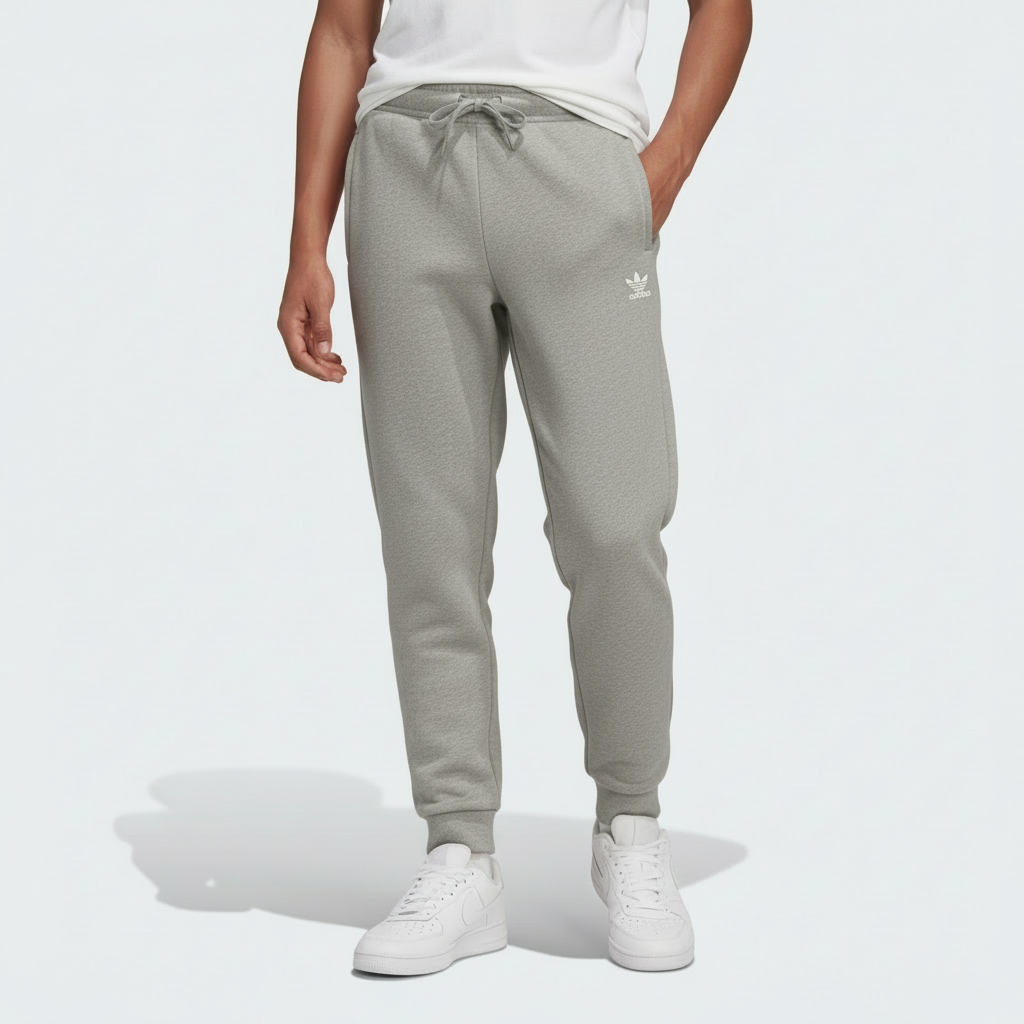 Kid wearing gray Adidas jogger pants on a white background