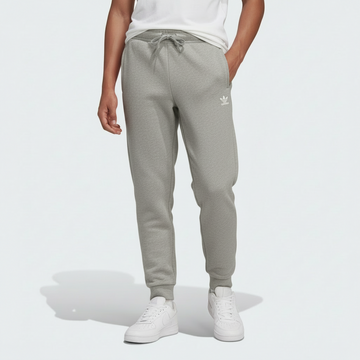 Kid wearing gray Adidas jogger pants on a white background