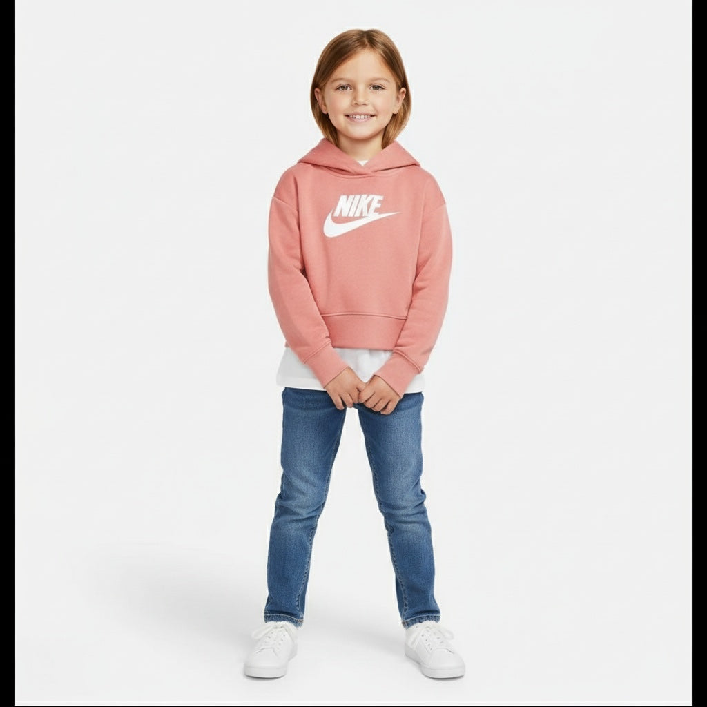 Child wearing a pink Nike hoodie and blue jeans on a white background