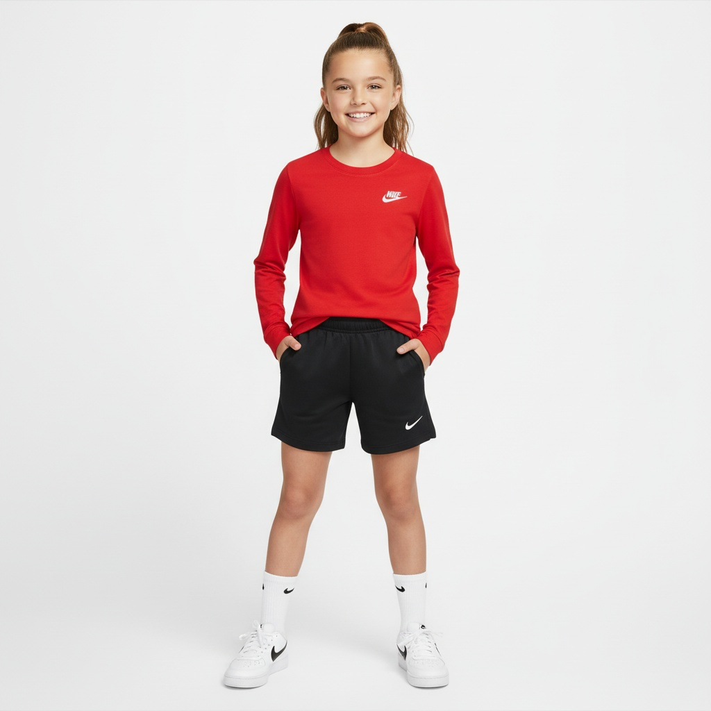 Child wearing a red Nike long-sleeve shirt and black shorts on a white background