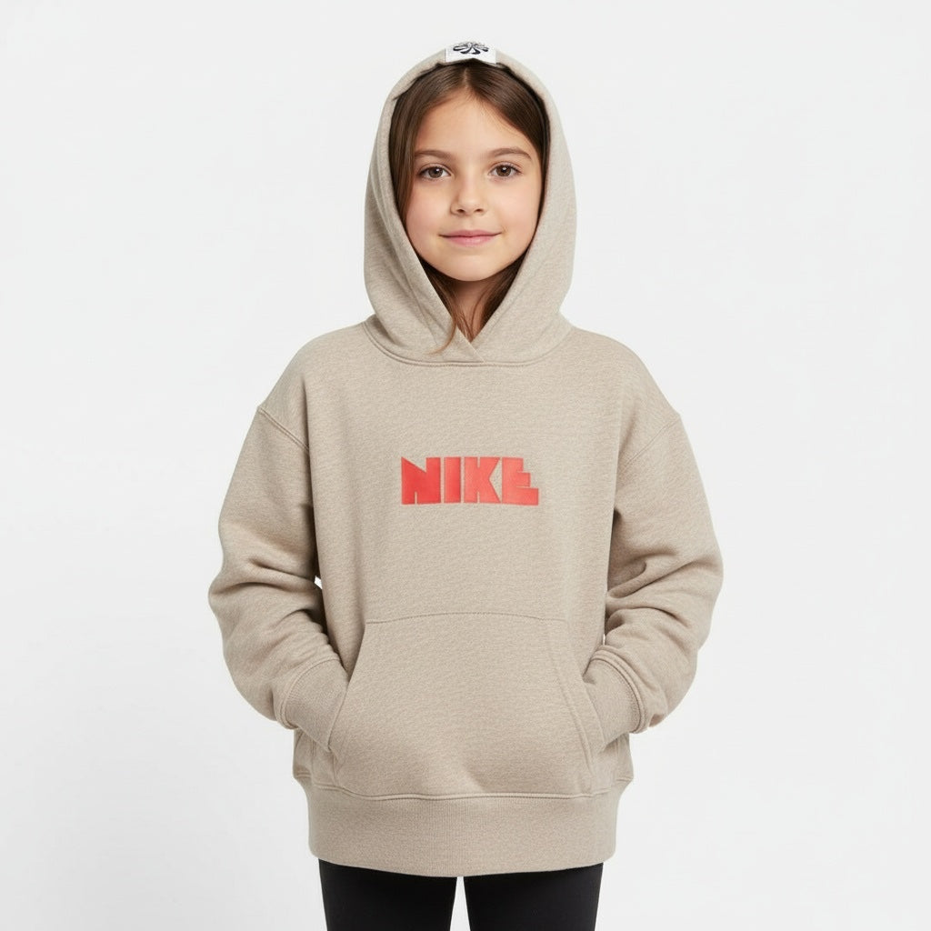 Child wearing a beige Nike hoodie on a white background