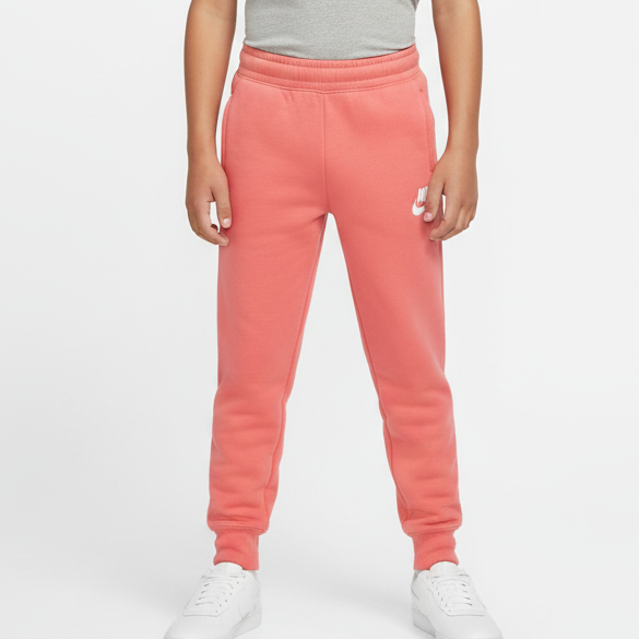 Child wearing a gray t-shirt and pink sweatpants on a white background