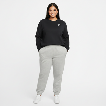 Woman wearing a black Nike sweatshirt and gray sweatpants on a white background