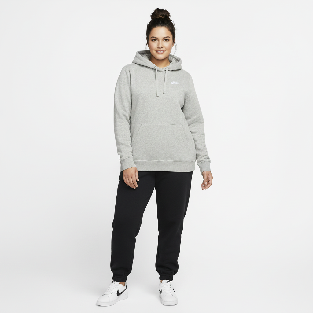Woman wearing a gray hoodie and black pants on a white background