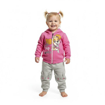 Child wearing a Paw Patrol pink hoodie with a cartoon character and gray pants on a white background