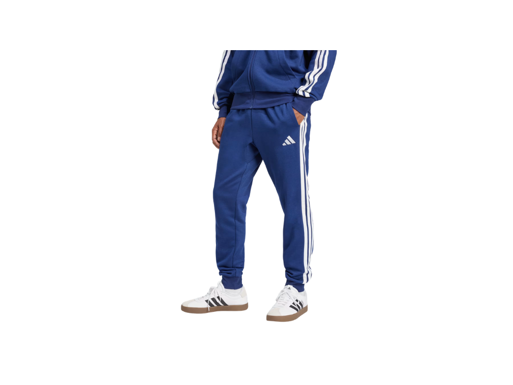 Person wearing a blue Adidas tracksuit on a white background