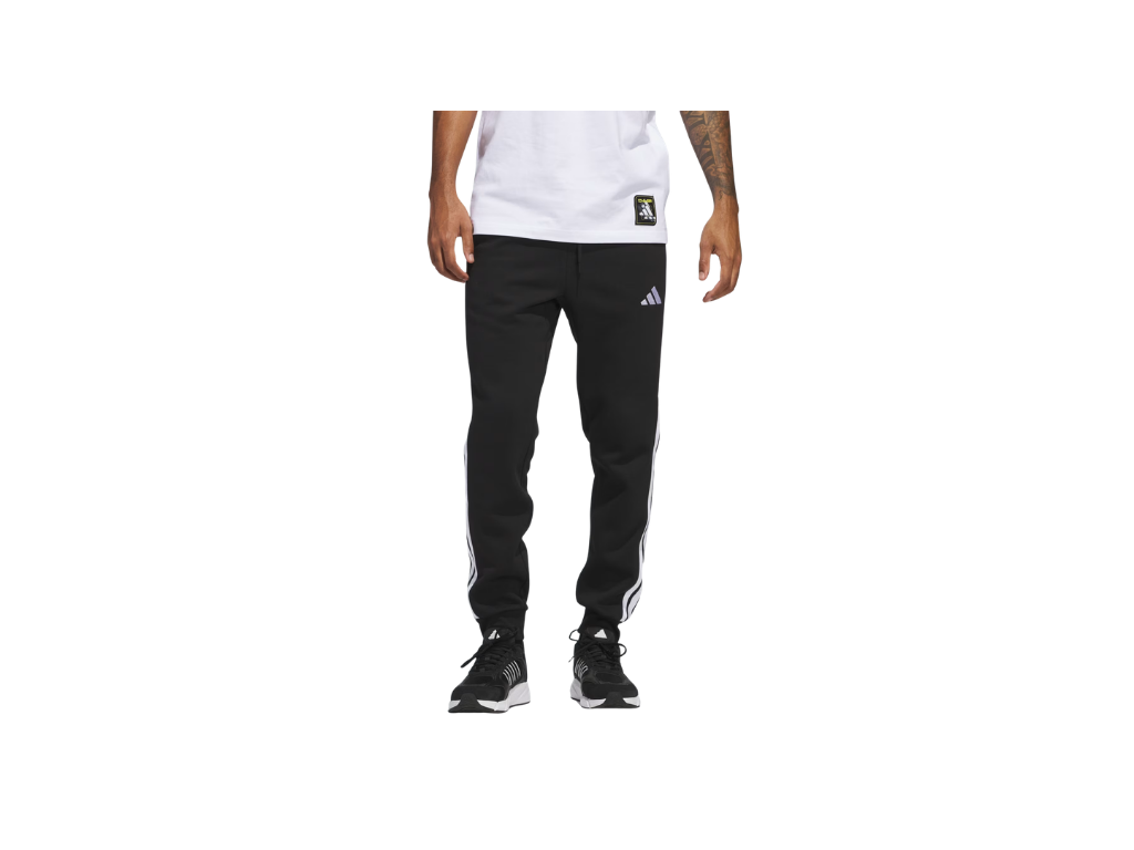 Person wearing black Adidas pants on a white background
