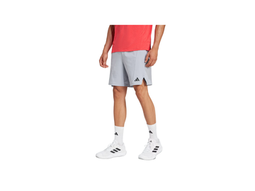 Person wearing gray Adidas shorts on a white background