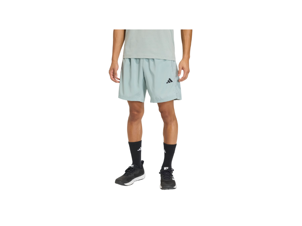 Person wearing light green athletic shorts with a brand logo on a white background