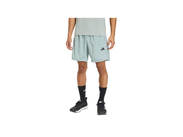Person wearing light green athletic shorts with a brand logo on a white background