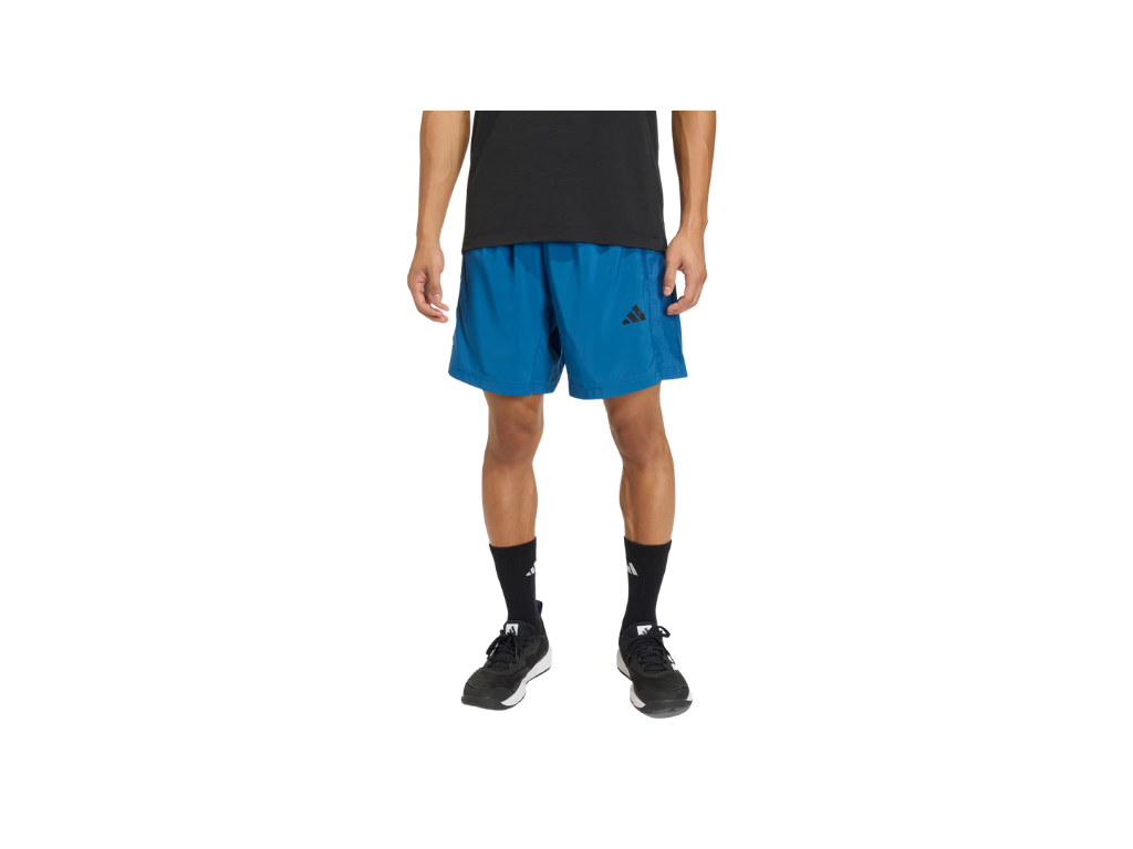Person wearing blue athletic shorts with a brand logo on a white background
